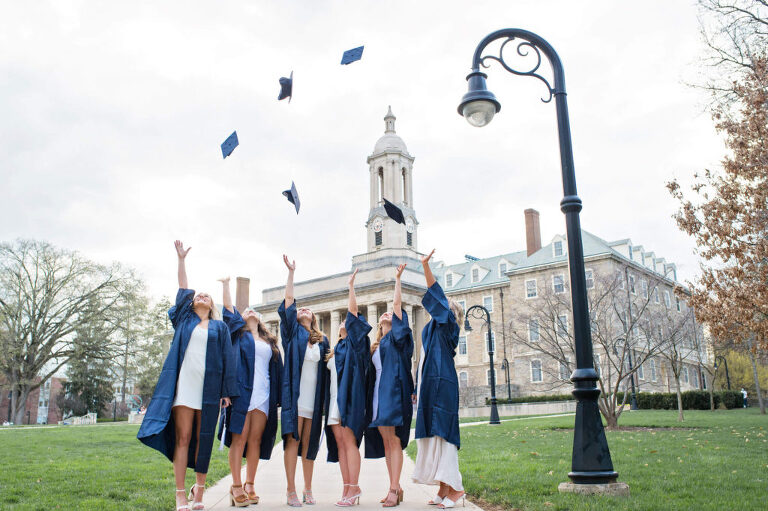 PSU grads throwing caps in air at Old Main, Penn State